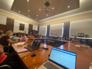 Wooden Tables in O Formation with BioMembrOS Members sitting around them and talking