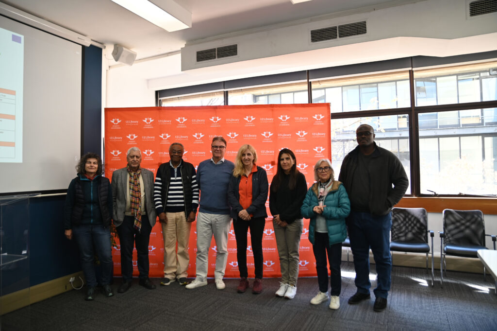Our team in front of a UJ Library Banner