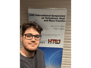 Mohsen Baghaei in front of the THMT Banner