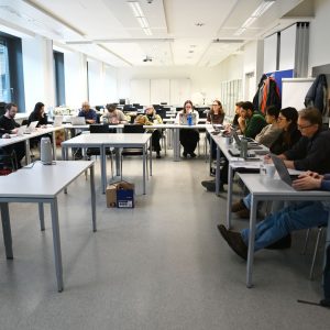 Overview of the meeting room with a U shaped table formation for our Consortium Meeting at Technische Universität Wien. Our members already sitting and listening to a presentation