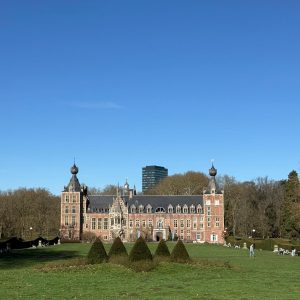 Castle of KU Leuven with a park in front and trees in the back